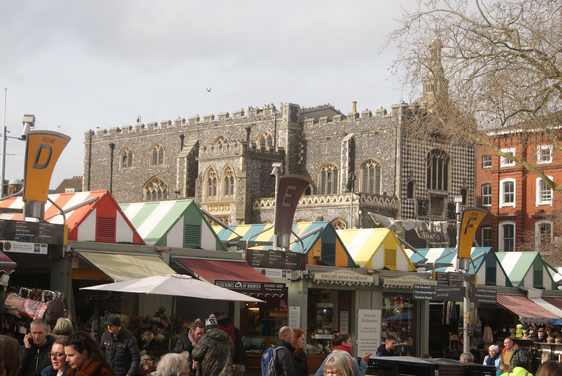 Norwich Guildhall behind the striped awnings of the market